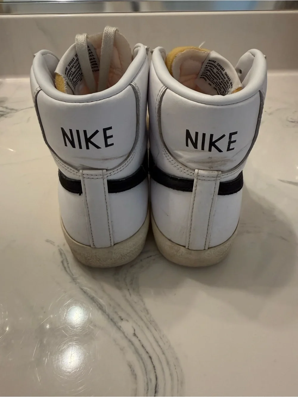 Nike White Sneakers with Black Swoosh and Red Nail Accent